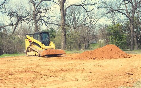 grade with excavator or skid steer|excavating with a skid steer.